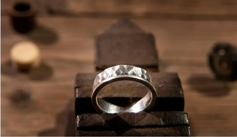a 925 silver ring on a wooden surface