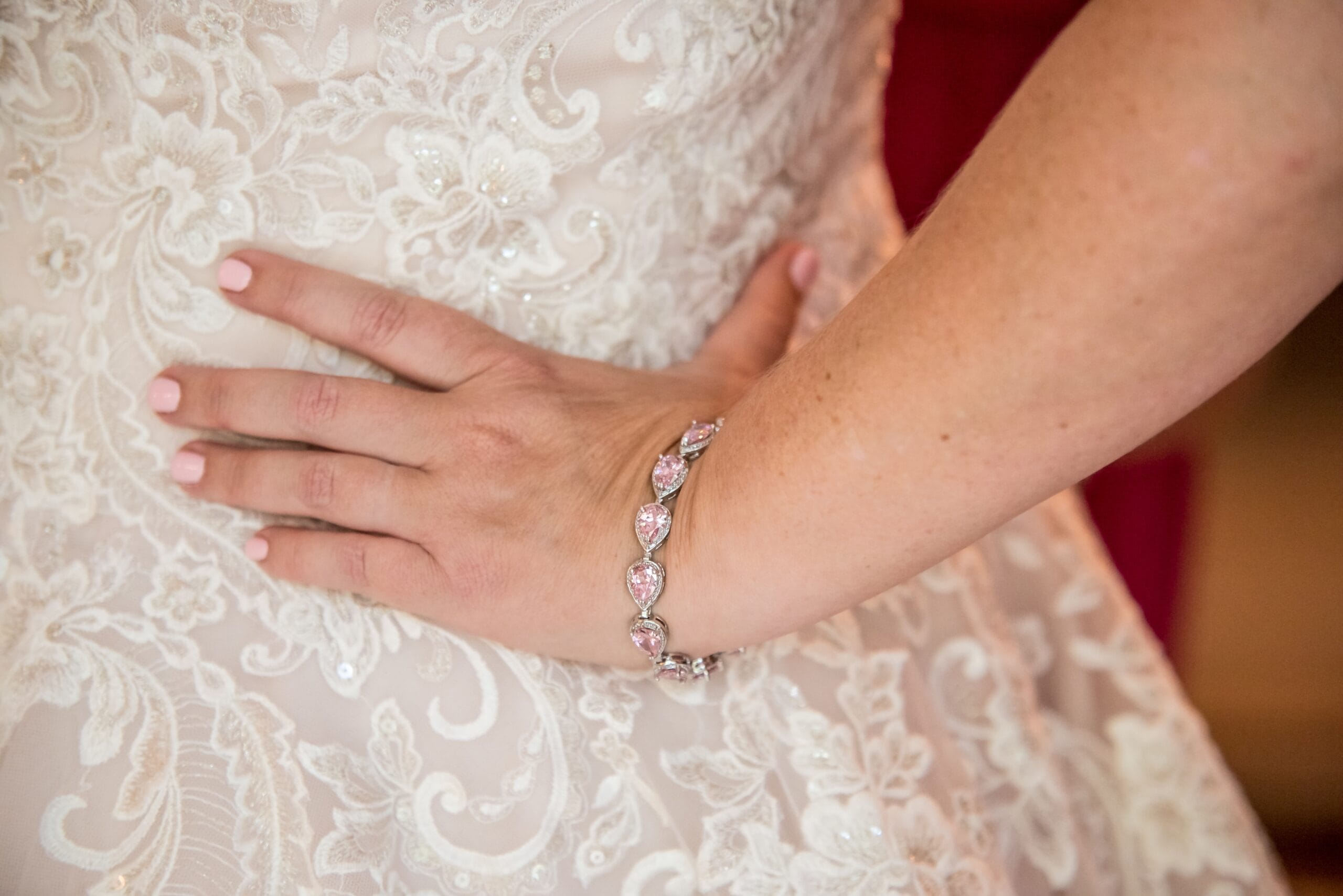 A showcase of a 925 silver bracelet on a bride's hand.