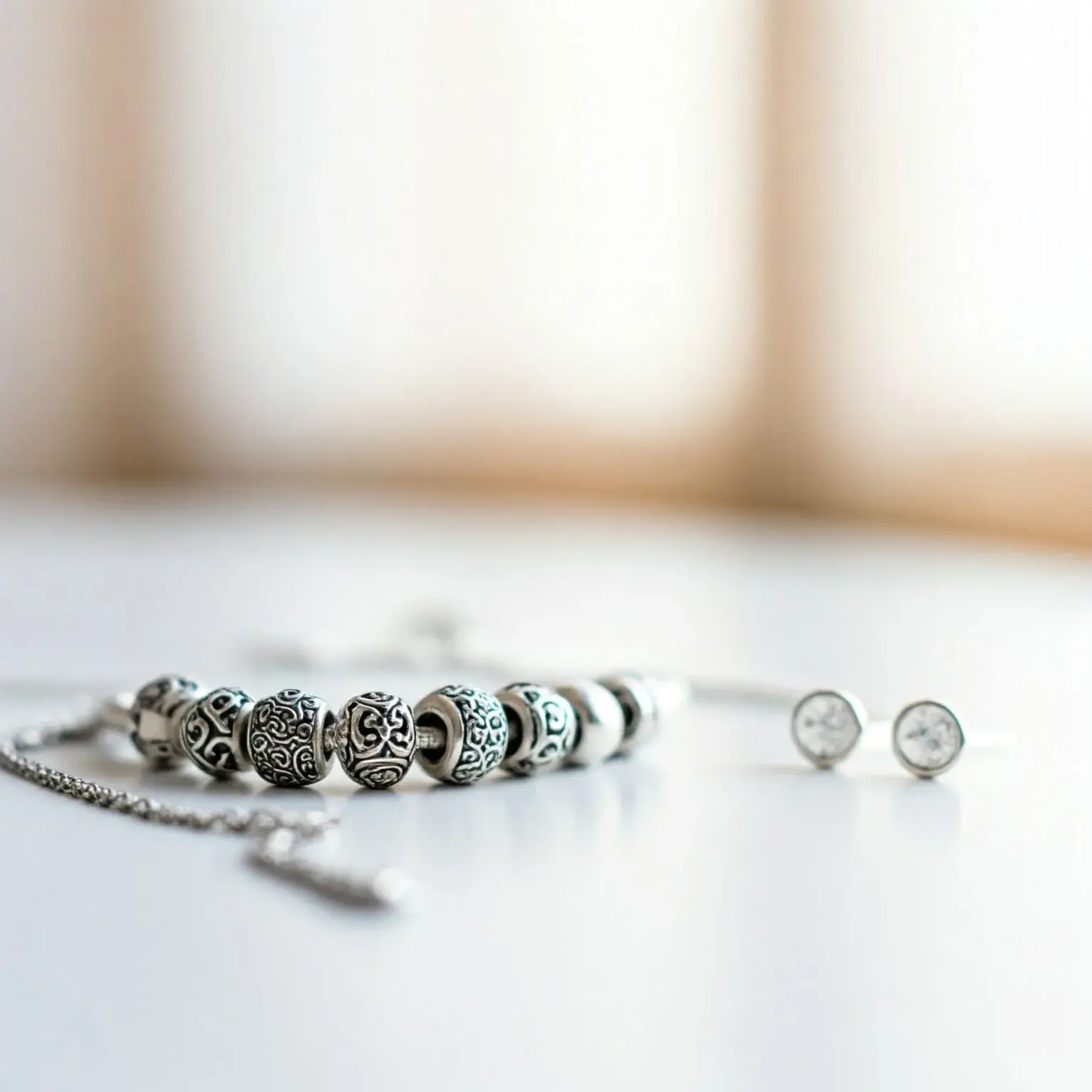 925 silver jewelry pieces on a light surface
